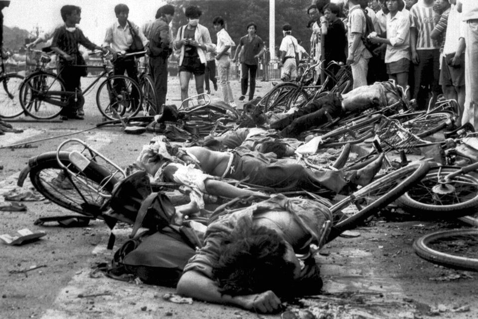 Bodies of dead civilians lie among mangled bicycles near Tiananmen Square in the early morning of June 4